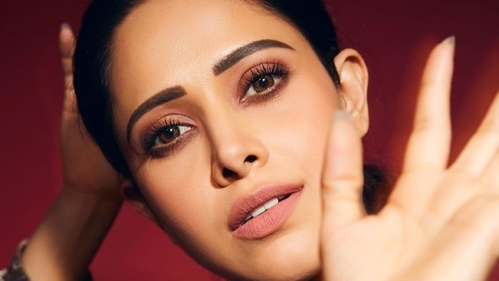 Wearing a dab of nude pink lipstick that matched her eyeshadow tint, Nushrratt amplified the glam quotient with highlighted cheeks, smudgy kohl-lined eyes, mascara-laden eyelashes and filled-in eyebrows.&nbsp;(Instagram/nushrrattbharuccha)