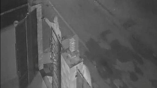 A closed-circuit television camera grab of the incident showing one of the men standing outside the gate and firing gunshots. (HT Photo)