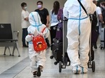 International travellers wearing personal protective equipment (PPE) arrive at Melbourne's Tullamarine Airport, on November 29.(AFP Photo) International travellers wearing personal protective equipment (PPE) arrive at Melbourne's Tullamarine Airport, on November 29.(AFP Photo)