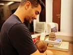 Angad Bedi feeds his one-month-old son. Angad Bedi feeds his one-month-old son.