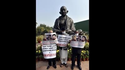 National Conference MPs Hassnain Masoodi, Farooq Abdullah and Akbar Lone outside the Parliament in New Delhi on Monday. (Sanjeev Verma/HT PHOTO)