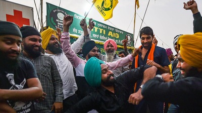 Farmers dance as they celebrate after Prime Minister Narendra Modi announced the repealing of the three central farm laws, on November 19 (PTI)