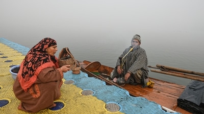 A fisherwoman prepares a Kangri during a cold and foggy morning at the banks of Dal Lake, in Srinagar (PTI Photo) A fisherwoman prepares a Kangri during a cold and foggy morning at the banks of Dal Lake, in Srinagar (PTI Photo)