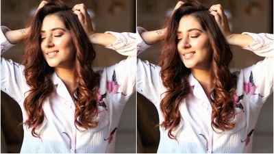 Disha teamed the shirt with matching flamingo printed pants in white shade and textured fabric. She completed the look with side-parted open tresses styled in defined curls and pastel blue nail paint. (Instagram/dishaparmar )