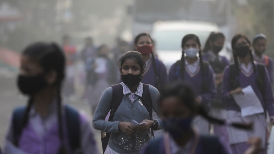 School girls walk towards a school as they reopened after remaining closed for nearly 15 days due to a spike in air pollution, on a smoggy morning in New Delhi(Reuters) School girls walk towards a school as they reopened after remaining closed for nearly 15 days due to a spike in air pollution, on a smoggy morning in New Delhi(Reuters)