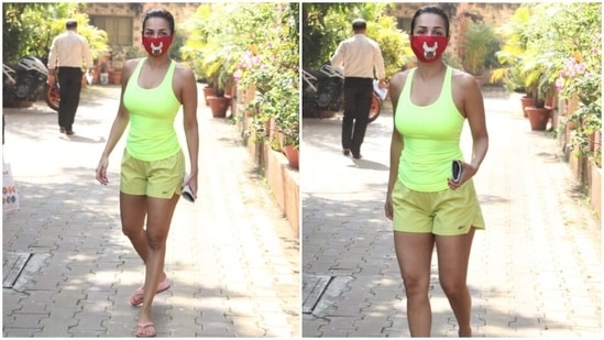 Malaika kept the gym look fuss-free by ditching all accessories with it. She kept herself safe with a red dog printed face mask. A sleeked back low bun, pink flip flops, make-up free skin, and red nail paint rounded it all off.