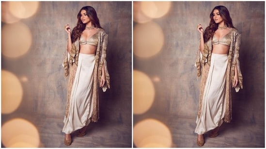 Tara's ensemble for the occasion features a sleeveless gold blouse in silk satin fabric. The bralette-style top comes with a plunging V neckline, broad straps to hold it in place, front button closures, and a cropped length baring the star's toned midriff.(Instagram/@tarasutaria)