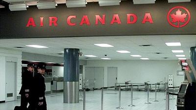 Air Canada pilots walk towards their gate at Toronto's Pearson International Airport. (REUTERS/FILE)
