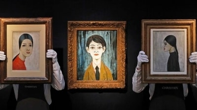 Christie's employees hold paintings by Laurence Stephen Lowry during an art pre-sale photo call at Christie's auction house in London, (AP Photo/Frank Augstein) (AP) Christie's employees hold paintings by Laurence Stephen Lowry during an art pre-sale photo call at Christie's auction house in London, (AP Photo/Frank Augstein) (AP)