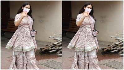 Sara carried her coffee mug as she waved at the paparazzi. (HT Photos/Varinder Chawla)