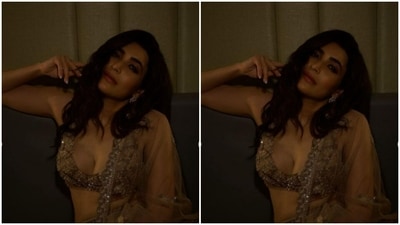 Karishma paired it with a long flowy skirt, decorated in mirror work, moti and zari. She completed her look with a golden georgette dupatta adorned with zari along the borders. (Instagram/@karishmaktanna)