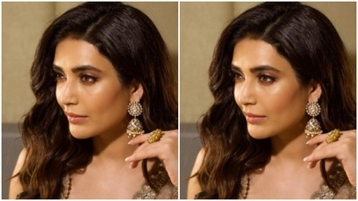Karishma accessorised her look with statement golden jhumkas and a gold ring from the house of Azotiique. (Instagram/@karishmaktanna)