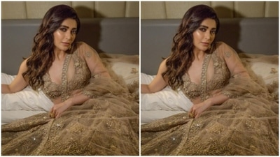 Styled by hair stylist Shefali, Karishma left her long tresses open in wavy curls with a side part. (Instagram/@karishmaktanna)