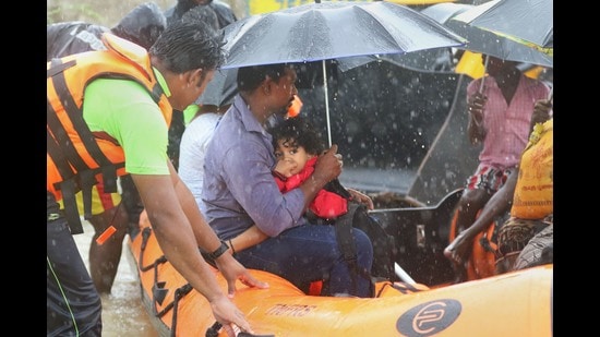 Tamil Nadu Fire and Rescue Services (TNFRS) team evacuates a family from a flood-affected area following heavy rains at Periyar Nagar near Chennai, Monday. (PTI)