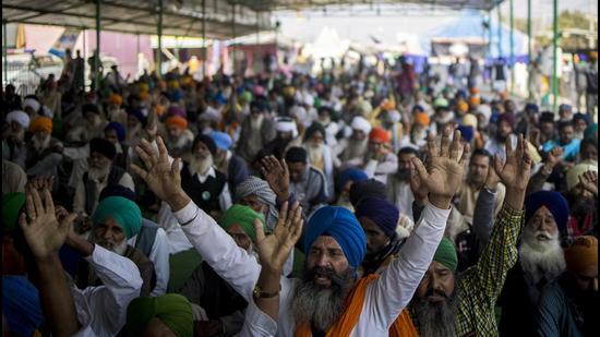 Protesting farmers raise their hands and shout slogans during a protest in New Delhi on November 29. (Bloomberg)