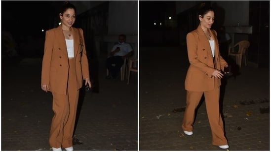 Tamannaah wore a chocolate brown suit as she stepped out in Mumbai. Her look was a chic mix of street style and elegant fashion. The powersuit featured a notch-lapel blazer with gold buttons on the front, long sleeves, puffed shoulders, and a figure-skimming fit.(HT Photo/Varinder Chawla)