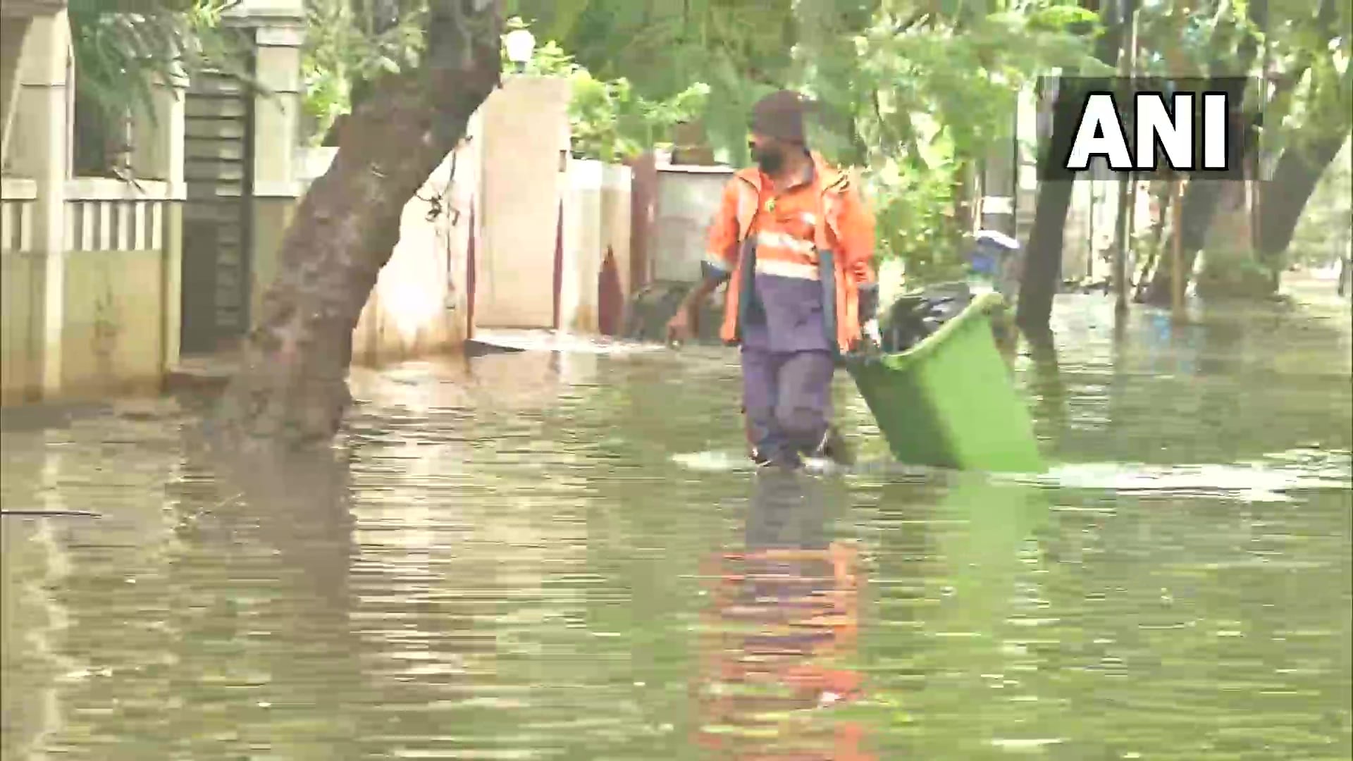 A person walks through waterlogged street in Chennai's Ashok Nagar area. (ANI photo)