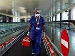 A laboratory technician carries swab samples collected from passengers amid the spread of the coronavirus disease (Covid-19) at Indira Gandhi International Airport, in New Delhi (REUTERS) A laboratory technician carries swab samples collected from passengers amid the spread of the coronavirus disease (Covid-19) at Indira Gandhi International Airport, in New Delhi (REUTERS)