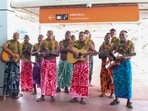 In this photo released by Tourism Fiji, guests receive a traditional Fijian welcome as they arrive at Nadi International airport in Fiji, Wednesday, Dec. 1, 2021. Fiji welcomed back its first tourists in more than 600 days on Wednesday after deciding to push ahead with reopening plans despite the threat posed by the omicron variant (AP) In this photo released by Tourism Fiji, guests receive a traditional Fijian welcome as they arrive at Nadi International airport in Fiji, Wednesday, Dec. 1, 2021. Fiji welcomed back its first tourists in more than 600 days on Wednesday after deciding to push ahead with reopening plans despite the threat posed by the omicron variant (AP)