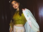 Often referred to as the national crush of India, Rashmika Mandanna knows how to keep fans hooked with her sartorial elegance and her latest pictures in a green crop top and floral coat are enough to back our claim.(Instagram/rashmika_mandanna)