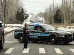 A police road block restricts access to Oxford High School following a shooting in Oxford, Michigan.