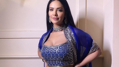 Leaving her sleek tresses open down her back in mid-parted hairstyle, Esha accessorised her look with a choker and a pair of jewelled earrings. Syled by fashion stylists Anisha Gandhi, Komal Soni and Rochelle D'sa Syiemiong, Esha amplified the glam quotient with a nude pink lipstick, rosy blushed and highlighted cheeks, mascara-laden eyelashes, black eyeliner streaks and filled-in eyebrows. (Instagram/egupta) Leaving her sleek tresses open down her back in mid-parted hairstyle, Esha accessorised her look with a choker and a pair of jewelled earrings. Syled by fashion stylists Anisha Gandhi, Komal Soni and Rochelle D'sa Syiemiong, Esha amplified the glam quotient with a nude pink lipstick, rosy blushed and highlighted cheeks, mascara-laden eyelashes, black eyeliner streaks and filled-in eyebrows. (Instagram/egupta)