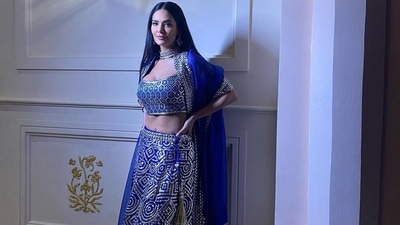 The blue base lehenga and choli came with intricate embroidery work in bright golden thread to enhance the rich look. While the blouse came with a deep neck and straps to ooze oomph, the lehenga was high-waist. (Instagram/egupta) The blue base lehenga and choli came with intricate embroidery work in bright golden thread to enhance the rich look. While the blouse came with a deep neck and straps to ooze oomph, the lehenga was high-waist. (Instagram/egupta)