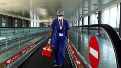 A laboratory technician carries swab samples collected from passengers amid the spread of the coronavirus disease (Covid-19) at Indira Gandhi International Airport, in New Delhi (REUTERS) A laboratory technician carries swab samples collected from passengers amid the spread of the coronavirus disease (Covid-19) at Indira Gandhi International Airport, in New Delhi (REUTERS)