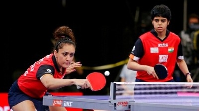 India's Manika Batra, left, returns a volley next to Archan Girish Kamath, right, during a quarterfinals women's doubles match during day five of the 2021 World Table Tennis Championships Saturday, Nov. 27, 2021, in Houston. (AP) India's Manika Batra, left, returns a volley next to Archan Girish Kamath, right, during a quarterfinals women's doubles match during day five of the 2021 World Table Tennis Championships Saturday, Nov. 27, 2021, in Houston. (AP)
