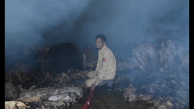 Factory owner Sushil Goyal, who was at his house at the time of the incident, said it is suspected that the fire broke out around half-an-hour before neighbours sounded the alert at around 8.45pm; the cardboard factory was situated in a congested street in Ludhiana (HT Photo)