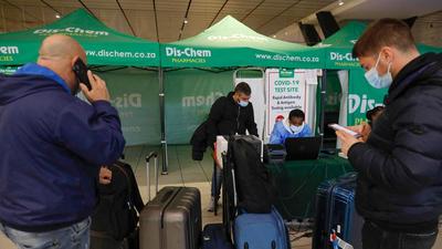 A healthcare worker assists a traveller to obtain his test results after conducting a PCR Covid-19 test at OR Tambo International Airport in Johannesburg. Apart from the initial entry ban, introduced last week, on those coming from seven southern African nations, Canada has also banned travellers from Egypt, Nigeria and Malawi over Omicron fears. (AFP) A healthcare worker assists a traveller to obtain his test results after conducting a PCR Covid-19 test at OR Tambo International Airport in Johannesburg. Apart from the initial entry ban, introduced last week, on those coming from seven southern African nations, Canada has also banned travellers from Egypt, Nigeria and Malawi over Omicron fears. (AFP)