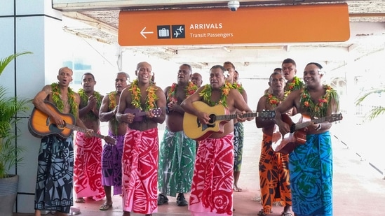 In this photo released by Tourism Fiji, guests receive a traditional Fijian welcome as they arrive at Nadi International airport in Fiji, Wednesday, Dec. 1, 2021. Fiji welcomed back its first tourists in more than 600 days on Wednesday after deciding to push ahead with reopening plans despite the threat posed by the omicron variant&nbsp;(AP)
