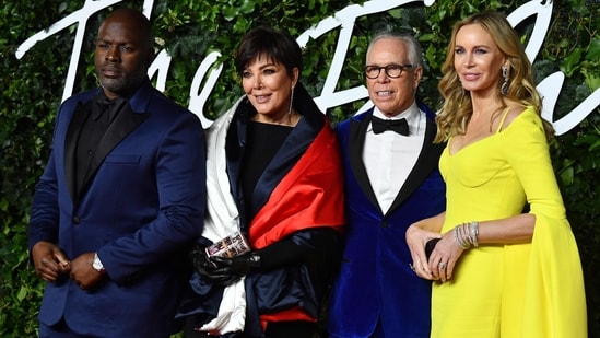 Corey Gamble and Kris Jenner pose with designer Tommy Hilfiger and US designer Dee Ocleppo on the red carpet upon arrival at The Fashion Awards 2021 in London.(AFP)