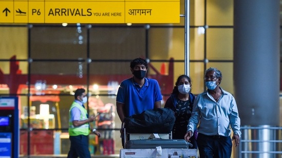 Arriving passengers leave a terminal at the Chhatrapati Shivaji Maharaj International Airport in Mumbai on December 1.(AFP Photo)