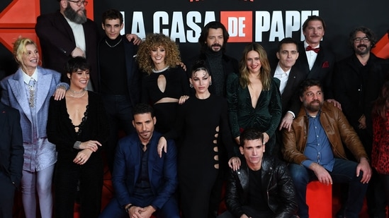 Casa de Papel cast members pose for a family picture during a photocall for the presentation of the last part of the fifth season of the Spanish TV show Money Heist (La Casa de Papel) at the Palacio Vistalegre arena in Madrid.(AFP)