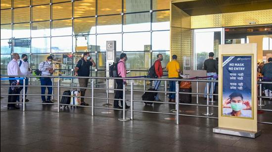 Passengers lined up at a terminal at the Chhatrapati Shivaji Maharaj International Airport, in Mumbai on Wednesday. (PTI)