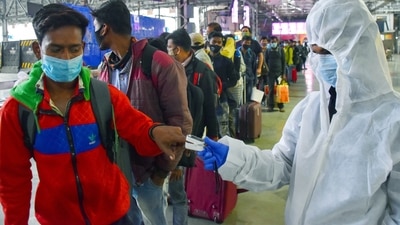 A healthcare worker checks the oxygen level of passengers arriving from other states, at Chhatrapati Shivaji Terminus in Mumbai on Thursday. (ANI Photo) A healthcare worker checks the oxygen level of passengers arriving from other states, at Chhatrapati Shivaji Terminus in Mumbai on Thursday. (ANI Photo)