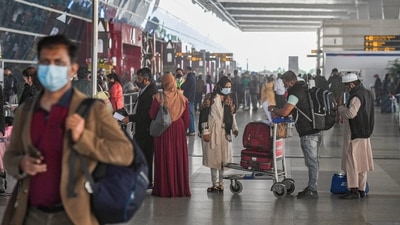 Travellers wait in a queue to get their luggage sanitised at the drop-off point before entering the Terminal-3 of Indira Gandhi International Airport, in New Delhi on December 2. (PTI) Travellers wait in a queue to get their luggage sanitised at the drop-off point before entering the Terminal-3 of Indira Gandhi International Airport, in New Delhi on December 2. (PTI)