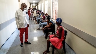 A hospital worker ensures people practice social distancing at a hospital near Johannesburg, South Africa, (AP) A hospital worker ensures people practice social distancing at a hospital near Johannesburg, South Africa, (AP)