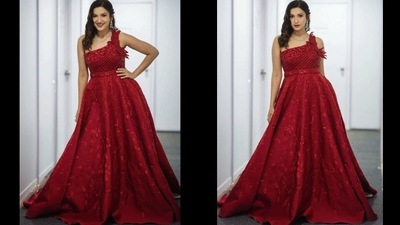 Taking to her social media handle, the actor shared a slew of pictures that featured her in the red silk gown that sported intricate embroidery all over and came with a bird cutout on the single shoulder. (Instagram/gauaharkhan)