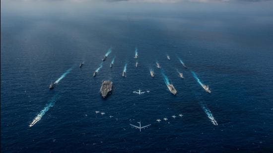 The aircraft carrier USS Ronald Reagan and the Japan Maritime Self-Defence Force helicopter destroyer JS Hyuga sail in formation with 16 other ships from the US Navy and the Japan Maritime Self-Defence Force as aircraft from the US Air Force and Japan Air Self-Defense Force fly overhead in formation during Keen Sword in the Philippine Sea. (REUTERS/FILE)