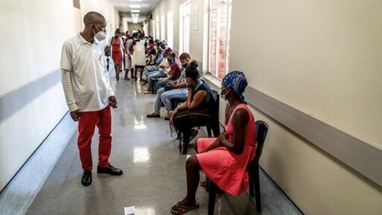 A hospital worker ensures people practice social distancing at a hospital near Johannesburg, South Africa,&nbsp;(AP)