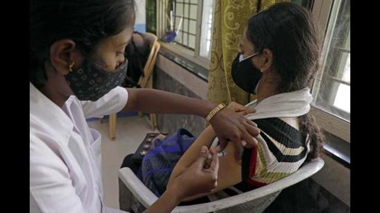In order to be prepared for the new Omicron variant, 28 oxygen plants will soon be installed in Pune. A health worker is seen giving a Covid-19 vaccine jab to a beneficiary at a vaccination centre at Sahakarnagar in Pune. (HT PHOTO)