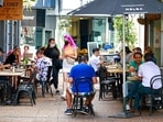 Customers eat outside in cafes in central Auckland, New Zealand, Friday, Dec. 3, 2021. (Alex Burton/NZ Herald via AP) Customers eat outside in cafes in central Auckland, New Zealand, Friday, Dec. 3, 2021. (Alex Burton/NZ Herald via AP)