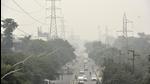 Noida, India - December 03, 2021: Vehicles ply on Sector 25 road on a hazy afternoon, in Noida, India, on Friday, December 03, 2021. (Photo by Sunil Ghosh / Hindustan Times) Noida, India - December 03, 2021: Vehicles ply on Sector 25 road on a hazy afternoon, in Noida, India, on Friday, December 03, 2021. (Photo by Sunil Ghosh / Hindustan Times)