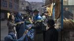 A man disributes bread to Burka-wearing Afghan women outside a bakery in Kabul, Afghanistan, on Thursday. (AP) A man disributes bread to Burka-wearing Afghan women outside a bakery in Kabul, Afghanistan, on Thursday. (AP)