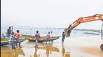 An earthmover is used to pull fishing boats ashore in view of the Cylone Jawad in Visakhapatnam on Friday. (PTI) An earthmover is used to pull fishing boats ashore in view of the Cylone Jawad in Visakhapatnam on Friday. (PTI)