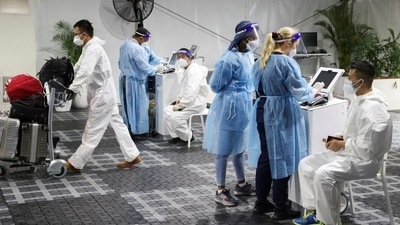 Travellers receive tests for the coronavirus disease (Covid-19) at a pre-departure testing facility, as countries react to the new coronavirus Omicron variant, outside the international terminal at Sydney Airport in Sydney, Australia. (REUTERS)