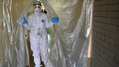 A medical staff wearing personal protective equipment leaves the intensive care unit in one of the hospitals. (AFP) A medical staff wearing personal protective equipment leaves the intensive care unit in one of the hospitals. (AFP)