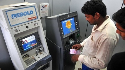 Currently, a customer has to pay  ₹20 per ATM withdrawal after five free transactions a month from a bank she has an account in. (HT/ PHOTO)